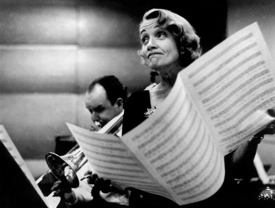 USA. New York City. Marlene DIETRICH at the recording studios of COLUMBIA RECORDS, who were releasing most of her songs she had performed for the troops during World War II, including LILI MARLENE, Miss Otis Regrets.She was 51 years old and starting a come-back in show business.It was a wet and cold November night and work could only begin at midnight, at the advise of Marlene's astrologer. November 1952. (C) Eve Arnold / Magnum Photos No Photograph or digital file may be reproduced, cropped or modified (digitally or otherwise), and its caption may not be altered without prior written agreement from the photographer or a Magnum representative.